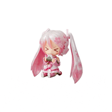 a pink and white figurine of a girl with a fan