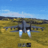 a fighter jet is flying over a field .