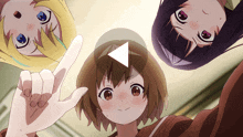 three anime girls are looking up at the camera and one is pointing at something