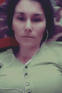 a woman wearing headphones and a green shirt that says " love "