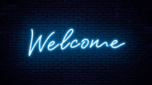 a neon sign that says welcome is on a brick wall .