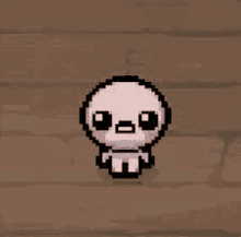 a pixel art drawing of a baby crying on a wooden surface .