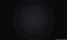 a black background with a gray gradient in the middle .