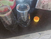 two empty glasses sit on a table next to a yellow cap that says ' gd ' on it