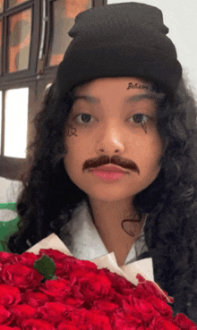 a woman with a fake mustache and a tattoo that says believe