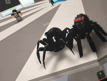 a black spider with red eyes is standing next to a person named dannie