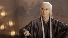 a man with long white hair is wearing a black kimono