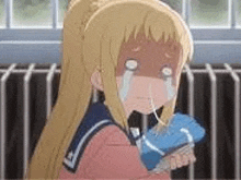 a girl is crying and holding a bottle of water .