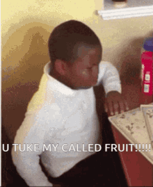 a young boy is sitting at a desk with the words " take my called fruit " written on the bottom