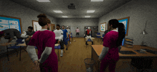 a group of people are standing in a classroom and one of them is wearing a pink shirt