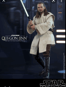 qui-gon jinn from star wars is holding a green lightsaber