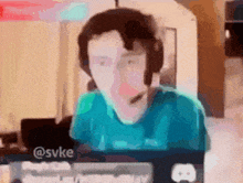 a blurry picture of a person wearing headphones and a keyboard with the username @svke