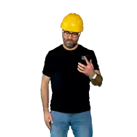 a man wearing a yellow hard hat and glasses looks at his phone
