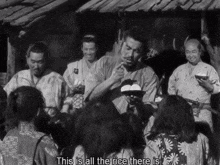 a group of people are gathered around a man holding a bowl of rice with the words this is all the rice there is below him