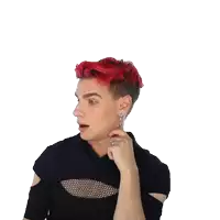 a man with red hair and a ring on his finger waves his hand