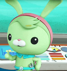 a green bunny with a pink headband is standing in front of a dashboard