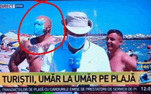 a man wearing a mask is being interviewed on a news channel