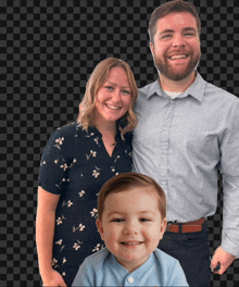 a man and woman standing next to a baby