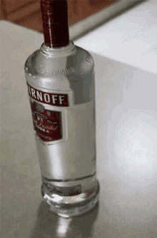 a bottle of smirnoff vodka sits on a table