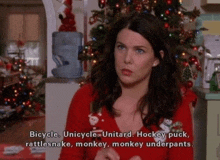 a woman in a red sweater says bicycle unicycle unitard hockey puck rattlesnakes monkey monkey underpants