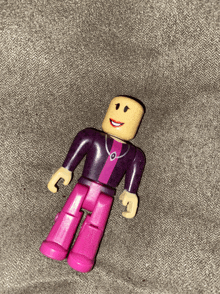 a pink and purple toy with a yellow head