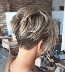 the back of a woman 's head with a short haircut