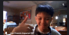 a young boy giving a thumbs up in a video call with the name uan francis imperial isip