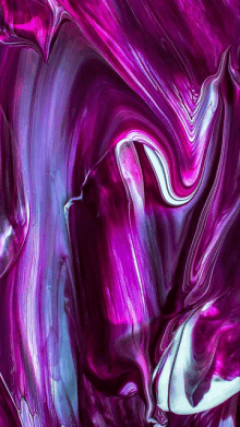 a close up of a purple and blue paint swirl .