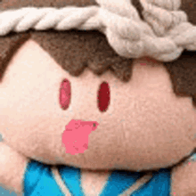 a close up of a stuffed animal with a rope around his head and a blue shirt .