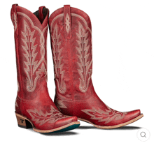 a pair of red cowboy boots with embroidery on them