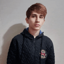 a young man wearing a black jacket with the word boxing on it