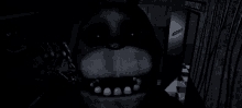 bonnie the bunny from five nights at freddy 's is standing in a dark room .