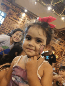 a little girl with her face painted with a butterfly