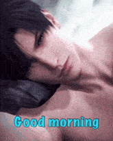 a shirtless man laying on a pillow with the words " good morning " written below him