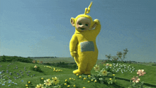 a yellow teletubbies standing in a field of flowers