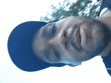 a close up of a man 's face wearing a black hat