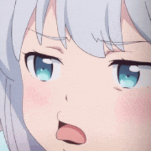 a close up of a girl with white hair and blue eyes making a funny face