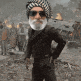 a man with a beard wearing sunglasses and a head scarf