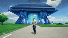 a man standing in front of a large blue building that says spectar