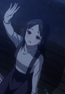 a girl with black hair and red eyes waves her hand