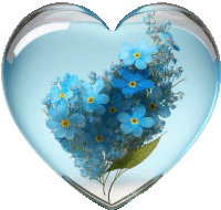 a heart shaped glass container with blue flowers inside of it