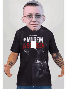 a man is wearing a black shirt that says #murem