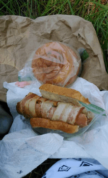 a bag of bread sits next to a bag of bacon wrapped sausage