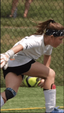 a female soccer player wearing a headband that says nike