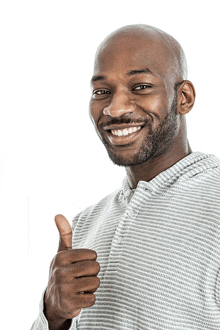 a man in a striped shirt is giving a thumbs up