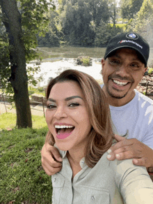 a man wearing a bmw motorsport hat smiles with a woman