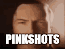 a close up of a man 's face with the words pinkshots written above him