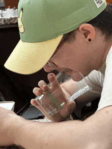 a man wearing a green hat with a pikachu on it