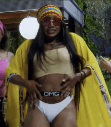 a woman wearing a yellow kimono and white underwear that says omg on it