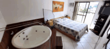 a bedroom with a large bed and a bathtub